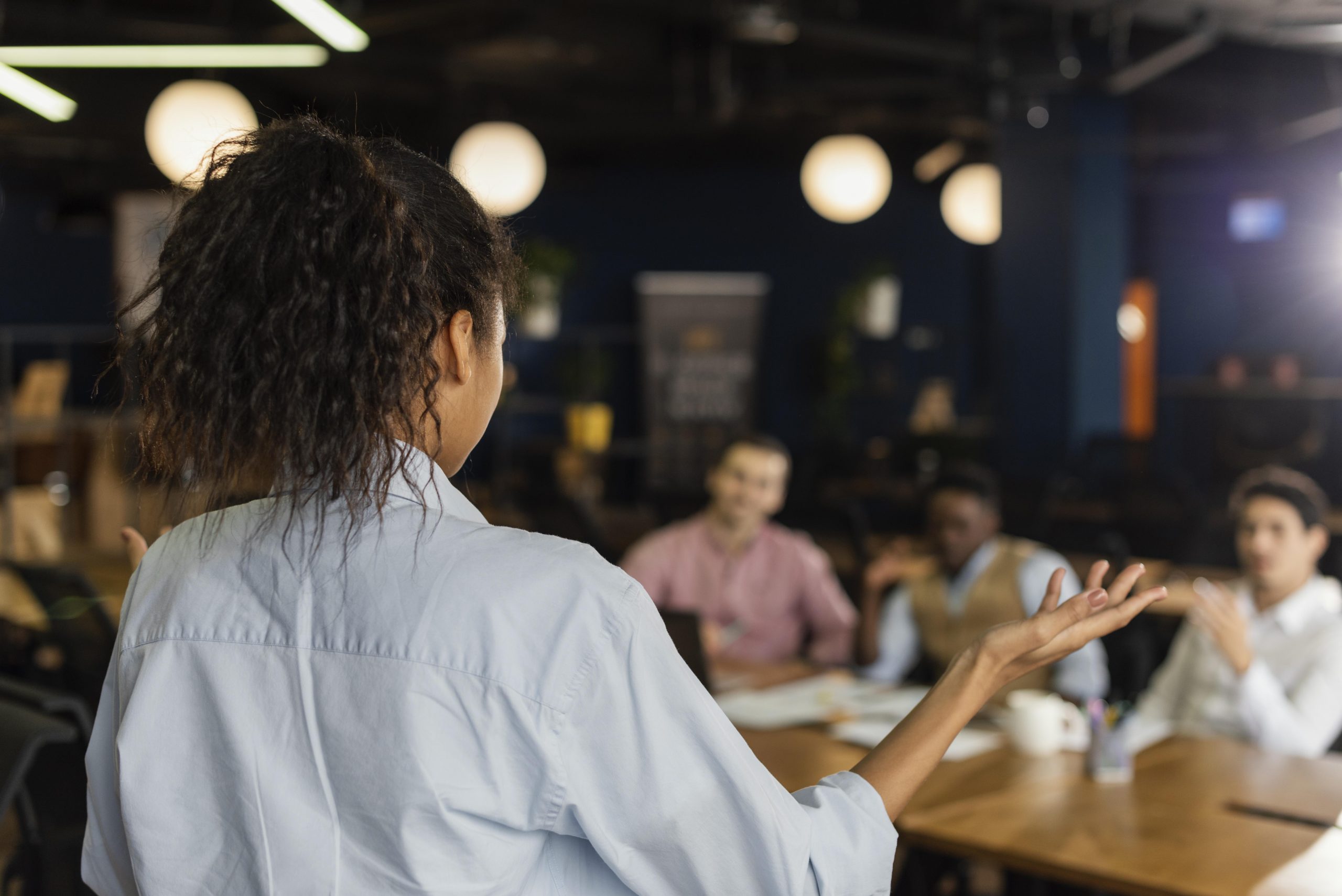 back-view-woman-holding-meeting-work-with-colleagues